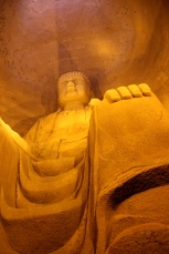 an enormous Buddha statue in a cavern